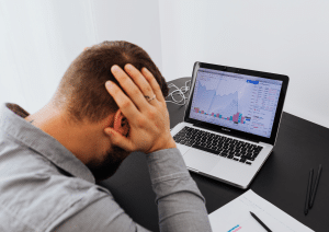 Anleger reagiert emotional auf fallende Börsenkurse am LaptopBehavioral Finance